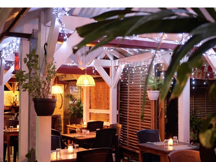 Terrasse illuminée du Jardin des Lucioles offrant une ambiance chaleureuse en Martinique